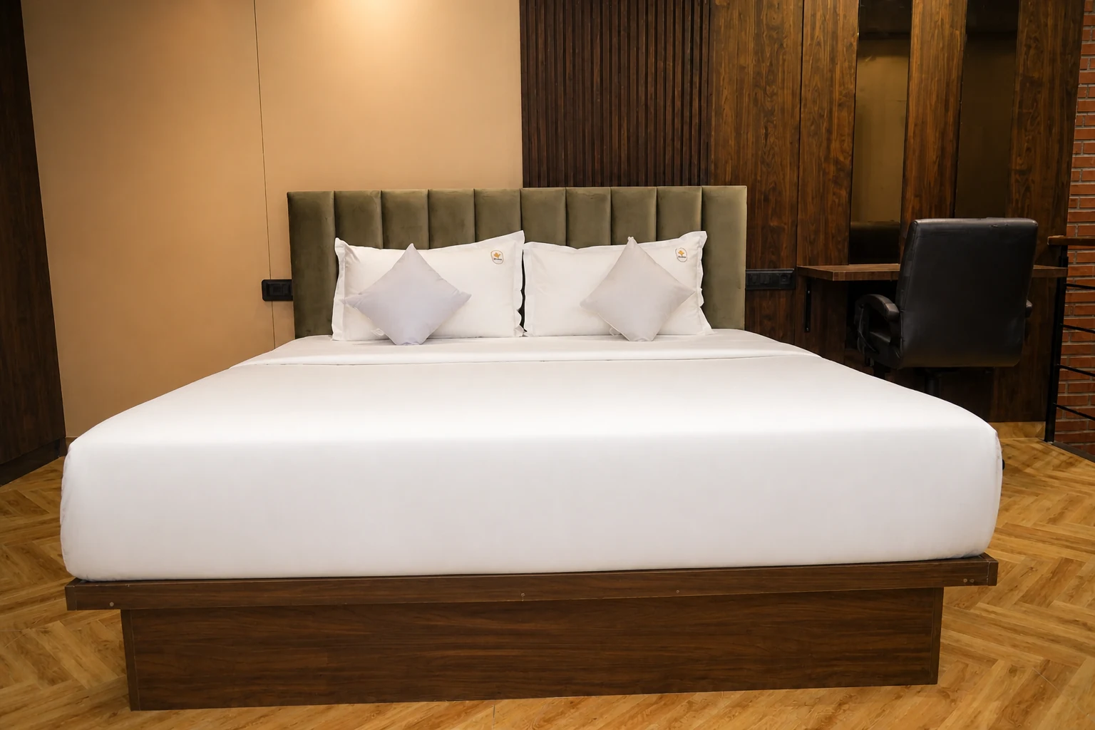 King-size bed on the upper sleeping level of a LuxStayz Loft apartment