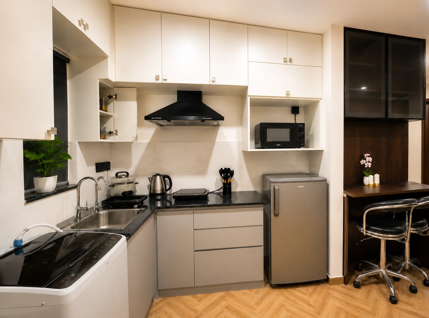 Kitchen and breakfast counter in the LuxStayz 1BHK Premium apartment
