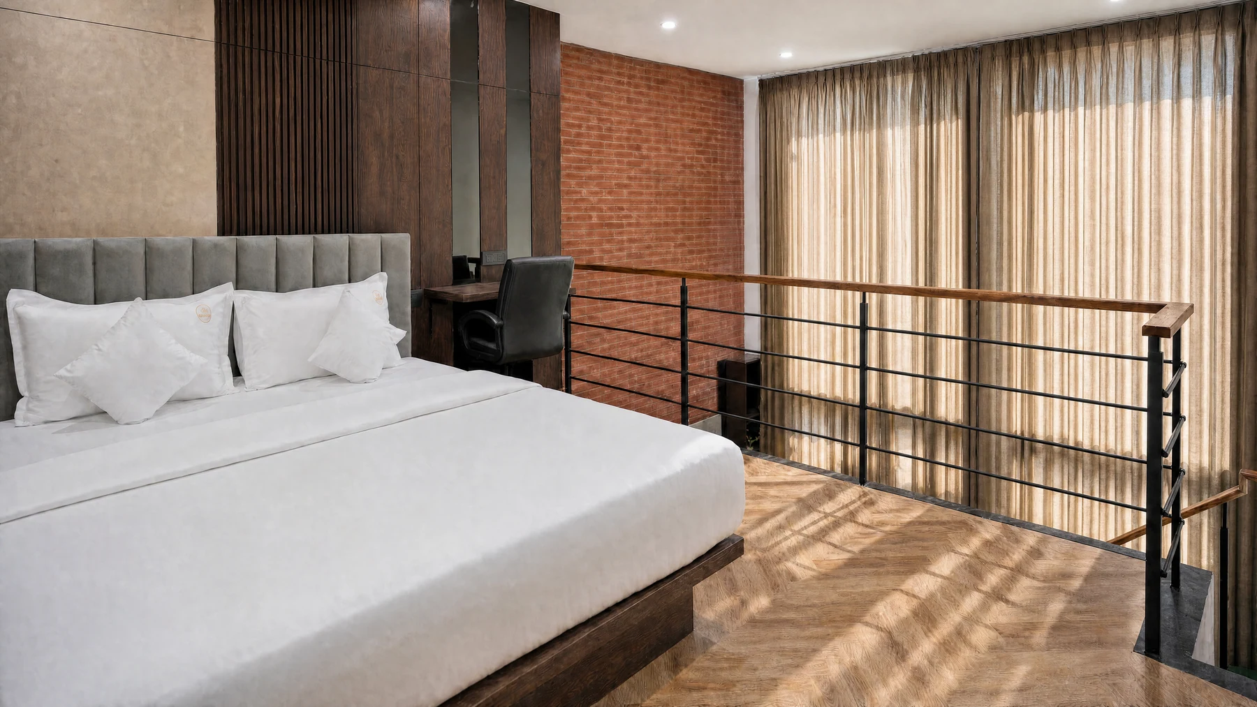 King-size bed on the upper level of the LuxStayz Loft Premium apartment