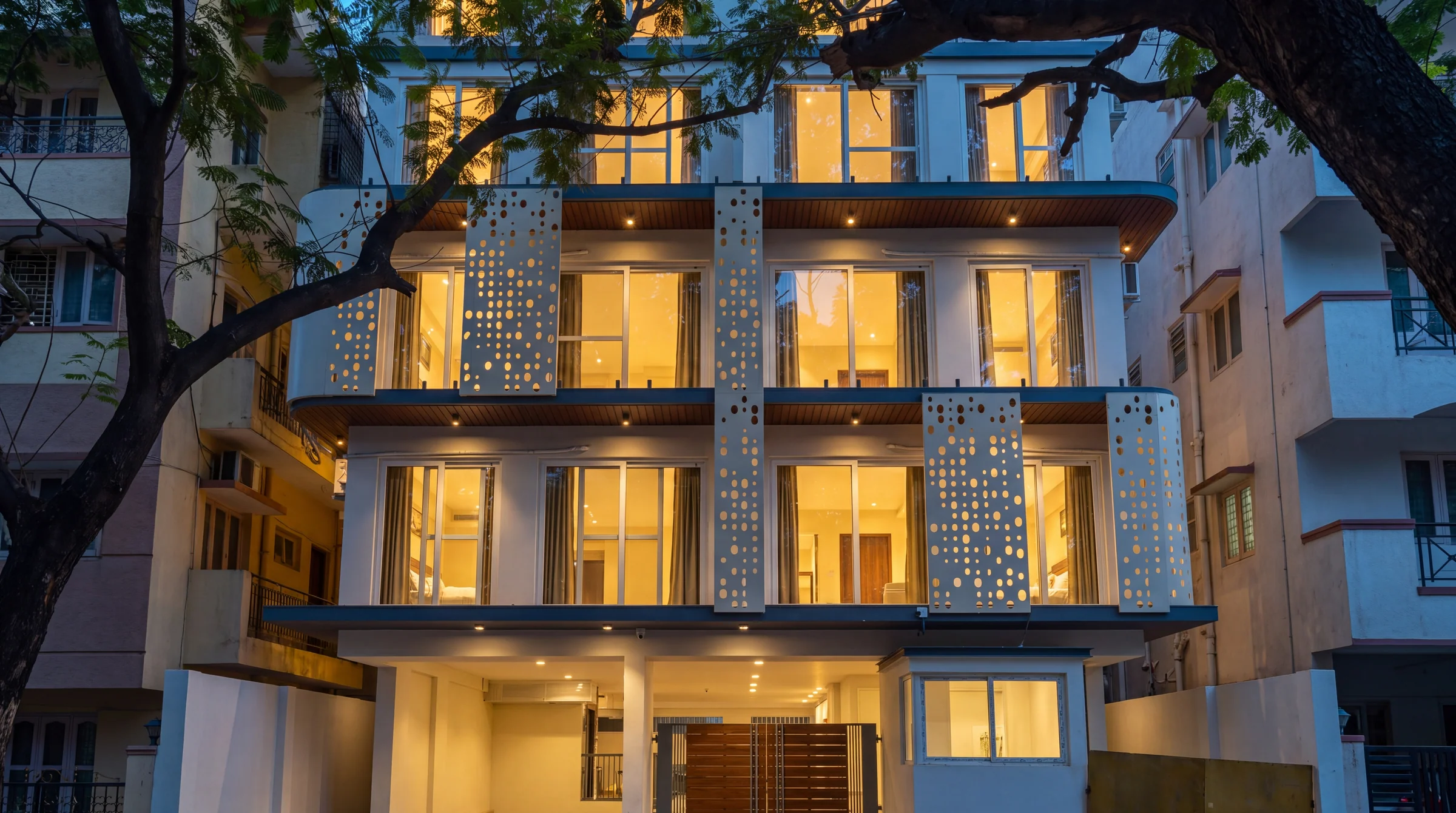 Blue-hour exterior of the real LuxStayz property in North Bengaluru