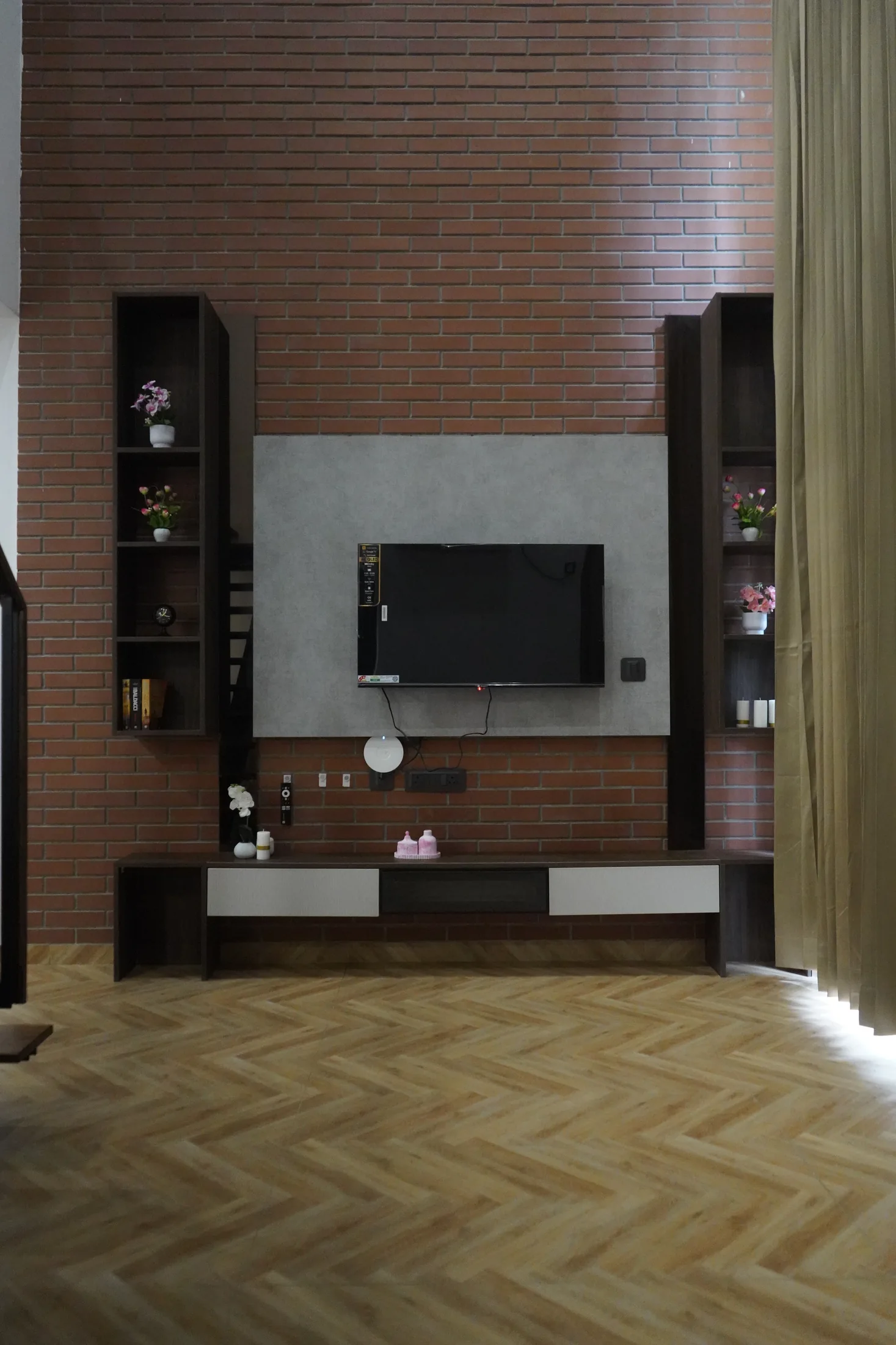 Double-height media wall and living area in a LuxStayz Loft apartment